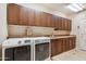 Convenient laundry room with ample cabinet space, modern appliances, and countertop for folding clothes at 25150 N Windy Walk Dr # 37, Scottsdale, AZ 85255
