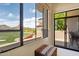 Bright living room with large windows offering golf course and mountain views and access to a private patio at 25150 N Windy Walk Dr # 37, Scottsdale, AZ 85255