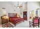 Spacious main bedroom with a ceiling fan, vaulted ceilings, and a luxurious bath at 25150 N Windy Walk Dr # 37, Scottsdale, AZ 85255