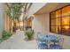 Covered patio with charming bistro set overlooking lush backyard at 25150 N Windy Walk Dr # 37, Scottsdale, AZ 85255