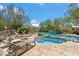 Relaxing backyard pool and spa with lounge chairs, natural rock features, and lush desert landscaping at 25150 N Windy Walk Dr # 37, Scottsdale, AZ 85255