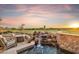 Backyard pool and spa with stone waterfall feature, desert landscaping, and views of the desert landscape at 25150 N Windy Walk Dr # 37, Scottsdale, AZ 85255