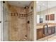 Modern bathroom shower with mosaic tile accent, glass doors, and vanity with dark wood cabinets at 25150 N Windy Walk Dr # 37, Scottsdale, AZ 85255