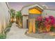 Side view of home with a flagstone walkway, bougainvillea and desert landscaping at 25150 N Windy Walk Dr # 37, Scottsdale, AZ 85255