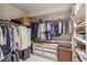 Spacious walk-in closet features custom shelving, hanging racks, and ample storage at 25150 N Windy Walk Dr # 37, Scottsdale, AZ 85255