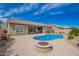 Backyard featuring a pool, a firepit, lush landscaping and a paver patio at 28623 N 66Th Ave, Phoenix, AZ 85083