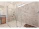 This bathroom features a spacious walk-in shower with stone tiling and a built-in bench at 28623 N 66Th Ave, Phoenix, AZ 85083