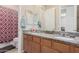The bathroom features a double sink vanity with granite countertops and decorative mirror at 28623 N 66Th Ave, Phoenix, AZ 85083