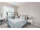 This bedroom boasts a cozy gray bed and soothing natural light from the window at 28623 N 66Th Ave, Phoenix, AZ 85083