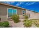 Exterior of home featuring vibrant red flowers and desert landscaping at 28623 N 66Th Ave, Phoenix, AZ 85083