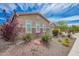 Inviting home with lush, low-water landscaping and stone accents on the facade at 28623 N 66Th Ave, Phoenix, AZ 85083