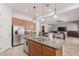 Open kitchen featuring stainless steel appliances, a spacious island, and seamless access to living area at 28623 N 66Th Ave, Phoenix, AZ 85083