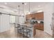 Modern kitchen with a large island, granite countertops, stainless steel appliances, and barn door access at 28623 N 66Th Ave, Phoenix, AZ 85083