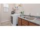 The laundry room includes new machines, a sink, and ample shelving space at 28623 N 66Th Ave, Phoenix, AZ 85083