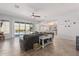 Living room with sliding doors to pool, barn doors, and a seamless connection to kitchen at 28623 N 66Th Ave, Phoenix, AZ 85083
