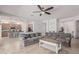A spacious living room featuring a comfortable sectional sofa with the kitchen in the background at 28623 N 66Th Ave, Phoenix, AZ 85083