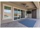 The covered patio includes an outdoor fan, a TV and views of the pool beyond at 28623 N 66Th Ave, Phoenix, AZ 85083