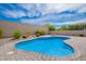 Backyard view of the pool surrounded by lush landscaping and a stone paver patio at 28623 N 66Th Ave, Phoenix, AZ 85083