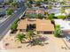 Real estate listing: Aerial view of a home, highlighting landscaping, desert landscaping, terracotta tile roof at 302 E Acapulco Ln, Phoenix, AZ 85022