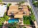 An aerial perspective of property with a backyard pool, patio, desert landscaping, and a terracotta tiled roof at 302 E Acapulco Ln, Phoenix, AZ 85022