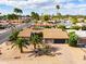 Aerial view of a home and desert landscape, featuring a terracotta tiled roof, desert landscaping, and street access at 302 E Acapulco Ln, Phoenix, AZ 85022