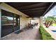 Covered patio with outdoor seating and access to backyard at 302 E Acapulco Ln, Phoenix, AZ 85022