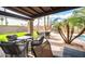 Covered patio with comfortable seating and desert landscaping near the pool at 302 E Acapulco Ln, Phoenix, AZ 85022
