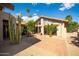 A backyard patio features desert landscaping, high ceilings, and large picture windows at 302 E Acapulco Ln, Phoenix, AZ 85022