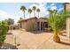 Paver patio with mature landscaping, a desert garden and an outdoor dining set at 302 E Acapulco Ln, Phoenix, AZ 85022