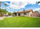 Picture of a fully fenced backyard featuring a pristine lawn, patio with dining area, and an additional storage shed at 302 E Acapulco Ln, Phoenix, AZ 85022