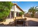 Paver patio with a wood outdoor dining set, lush foliage and large windows for natural light at 302 E Acapulco Ln, Phoenix, AZ 85022