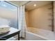 Spa-like bathroom offers a jetted tub, a large window, and built-in shelving for storage at 302 E Acapulco Ln, Phoenix, AZ 85022