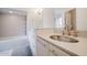 Bright bathroom with white cabinets, granite countertops, and a shower-tub combo at 302 E Acapulco Ln, Phoenix, AZ 85022