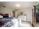Sunlit bedroom with a light fixture and a door leading outside at 302 E Acapulco Ln, Phoenix, AZ 85022