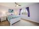 Comfortable bedroom boasts a large window with curtains, a ceiling fan, and a closet at 302 E Acapulco Ln, Phoenix, AZ 85022