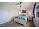 Cozy bedroom features a ceiling fan, a large window, and a closet at 302 E Acapulco Ln, Phoenix, AZ 85022