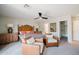 Spacious bedroom with ceiling fan, seating area, and a walk-in closet at 302 E Acapulco Ln, Phoenix, AZ 85022