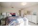 Bright bedroom with a decorative bedspread, soft carpet, and a white dresser at 302 E Acapulco Ln, Phoenix, AZ 85022