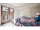 Cozy bedroom with patio access, a colorful bedspread, and neutral walls at 302 E Acapulco Ln, Phoenix, AZ 85022