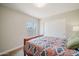 Inviting bedroom features a large window, a closet, and carpet floors at 302 E Acapulco Ln, Phoenix, AZ 85022