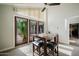 Bright dining area features modern table and seating with large windows and sliding door at 302 E Acapulco Ln, Phoenix, AZ 85022