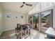 Dining area features modern table and seating with large windows and sliding door at 302 E Acapulco Ln, Phoenix, AZ 85022