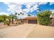 Charming single-story home with a spacious driveway, desert landscaping, and a terracotta-tiled roof at 302 E Acapulco Ln, Phoenix, AZ 85022