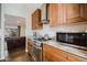 Well-lit kitchen with stainless steel appliances, light granite countertops, and ample cabinet space at 302 E Acapulco Ln, Phoenix, AZ 85022