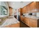 Bright kitchen features stainless steel appliances, granite counters and wooden cabinets at 302 E Acapulco Ln, Phoenix, AZ 85022