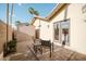 Charming patio area outside the house, featuring a brick surface, shade, seating, and a storage shed at 302 E Acapulco Ln, Phoenix, AZ 85022