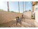 Cozy patio area showing paved surfaces and seating near the home's backyard block wall and storage shed at 302 E Acapulco Ln, Phoenix, AZ 85022