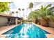 Swimming pool with palm trees and a well-kept patio and yard at 302 E Acapulco Ln, Phoenix, AZ 85022