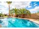 Bright swimming pool with nearby tables and desert landscaping at 302 E Acapulco Ln, Phoenix, AZ 85022