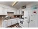 Well-lit kitchen featuring granite countertops, white cabinetry, and modern appliances at 3311 E Harvard St, Phoenix, AZ 85008